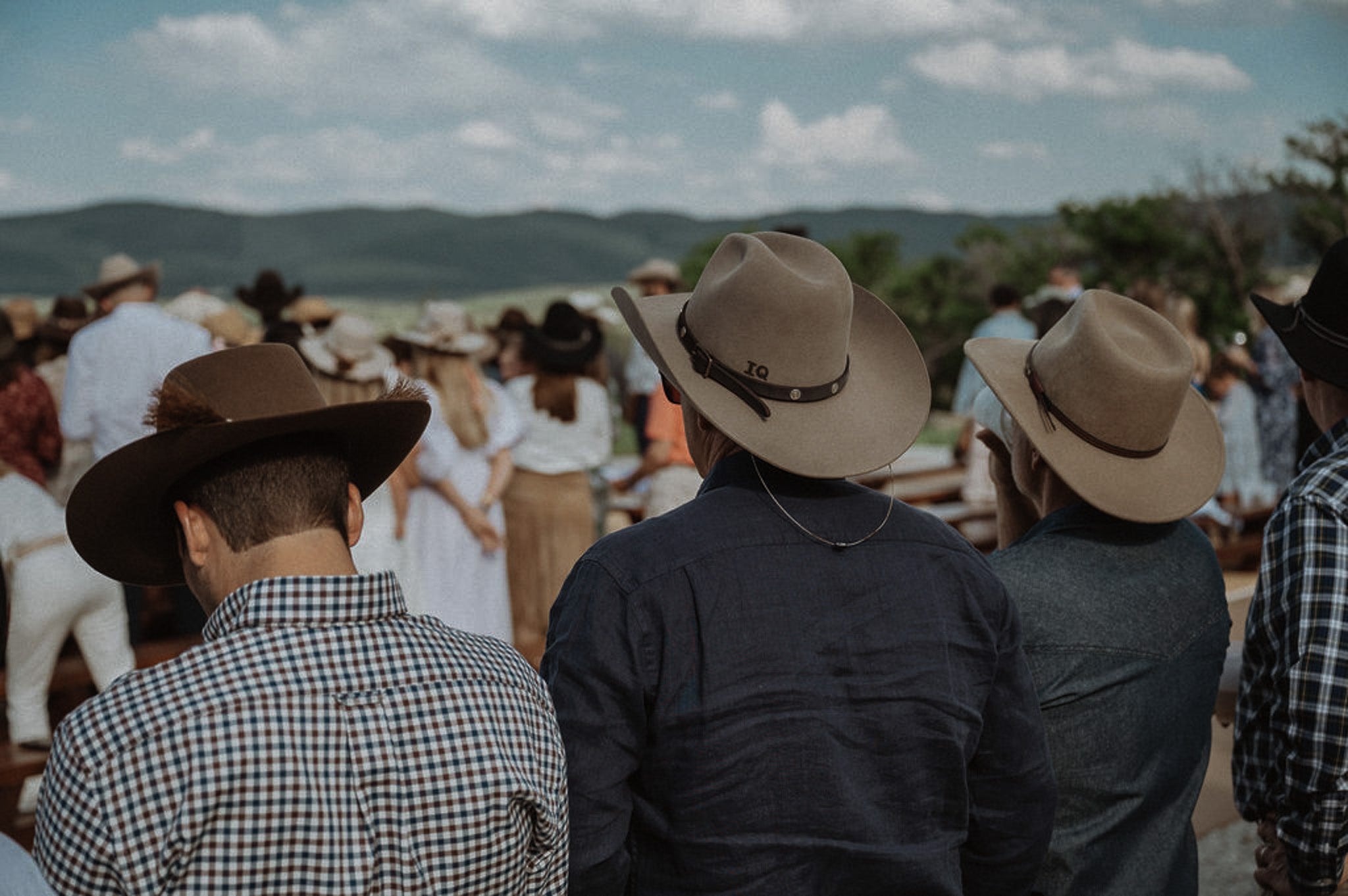 Custom event photo of three men in custom shaped cowboy hats
