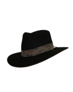 Three-quarter angled view of a black teardrop crown fedora with a speckled black and white feather hat band and burnt brim edge
