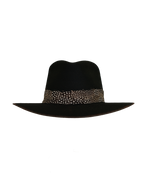 Three-quarter angled top view of a black teardrop crown fedora with a speckled black and white feather hat band and burnt brim edge