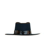 Back view of a navy wide-brim fedora with a teardrop crown, multicolor feather hat band in rust, white, and speckled tones.

