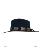 Side profile view from front to back of a navy wide-brim fedora with a teardrop crown, multicolor feather hat band in rust, white, and speckled tones.
