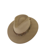 Top angled view of a greenish tan wide-brim fedora with a teardrop crown crease and, multicolored neutral feather hat band.