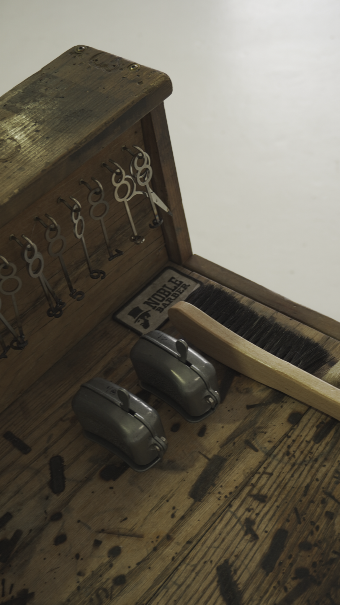 Wooden tool chest with tools on top of a portable wooden hat steamer