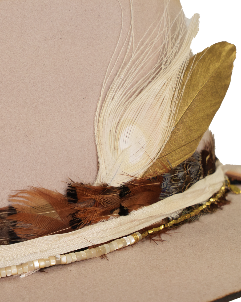 Close-up view of a light tan wide-brim felt fedora with a hand-burned crown edge and layered feather hat band with quartz stones.